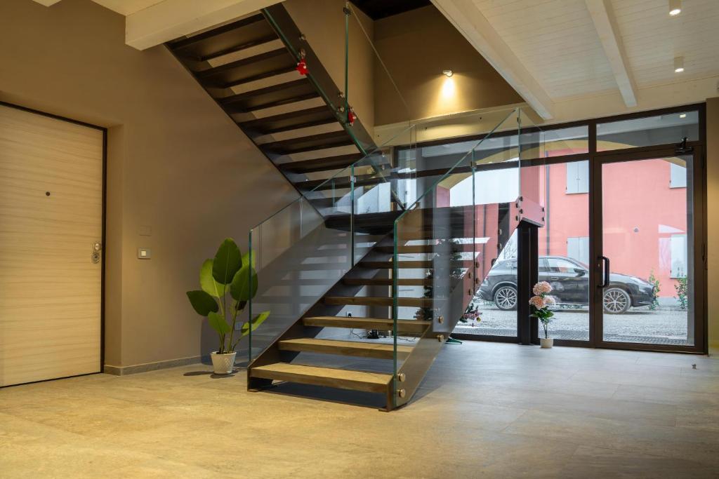 a staircase in a house with a glass railing at Villa Eliseo in Modena