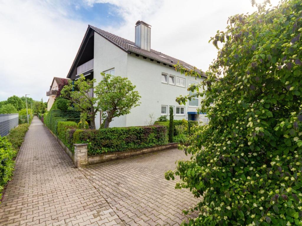 a brick path in front of a white house at Apartment ApartmentmitAusblick by Interhome in Wörth am Rhein