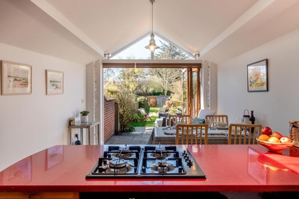 a kitchen with a red counter top and a stove at 2 Bed in Aldeburgh oc-fsh in Aldeburgh