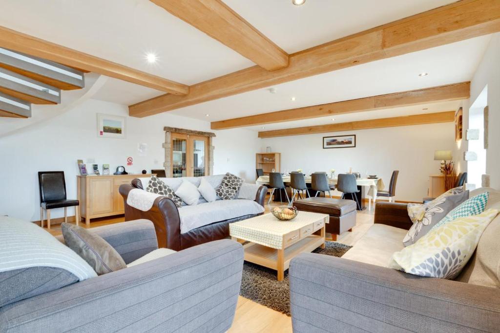 a large living room with couches and a table at 4 Bed in High Peak oc-dcchb in Chinley