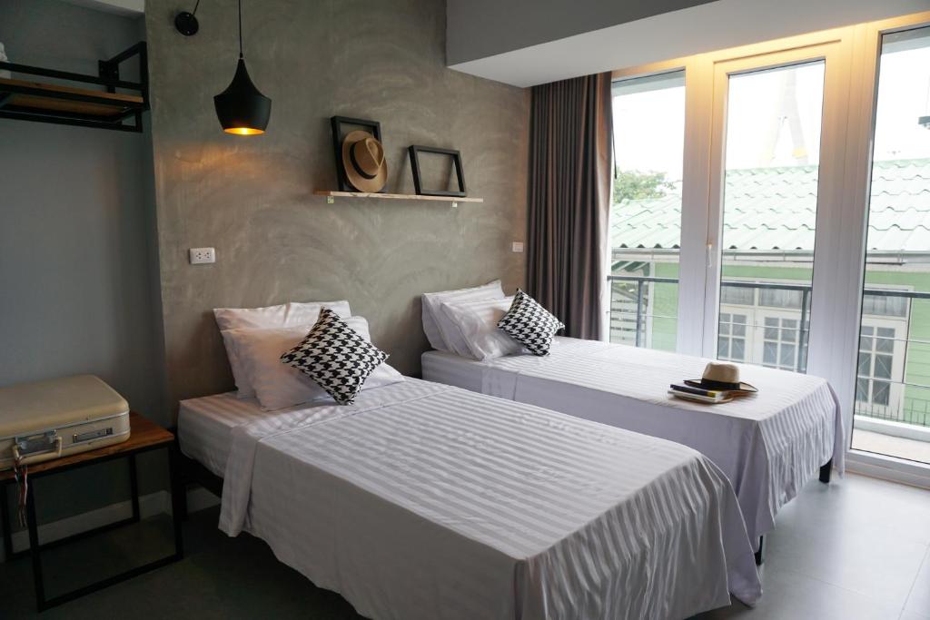 Postel nebo postele na pokoji v ubytování Hansa Bangkok House