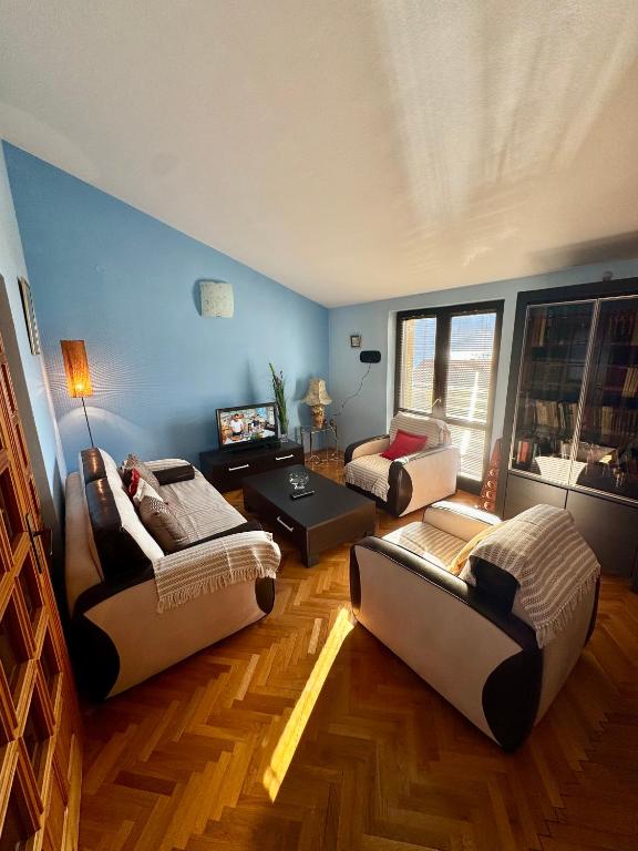 a living room with two couches and a table at Apartment Magdalena in Dobrota