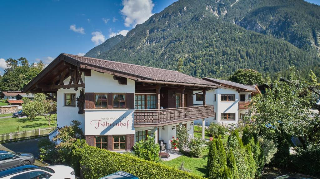 a house with a mountain in the background at Föhrenhof Apartments in Farchant