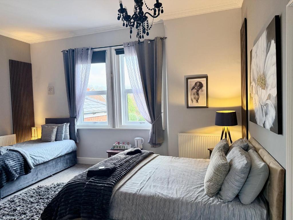 a bedroom with a bed and a window at St Andrews house Hotel in Preston