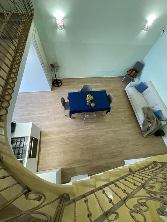 a living room with a blue table and a couch at Corso Suite Gallipoli in Gallipoli