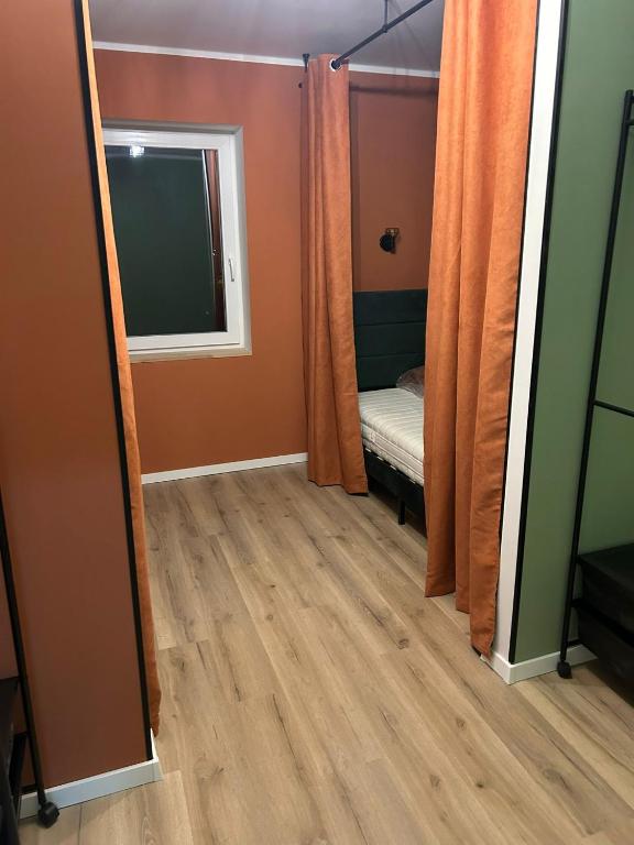 a mirror in a room with a bed and a window at B-Hostel in Kassel