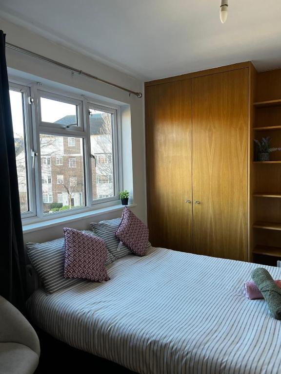 a bedroom with a large bed with pillows on it at Urban Snooze in Herne Hill