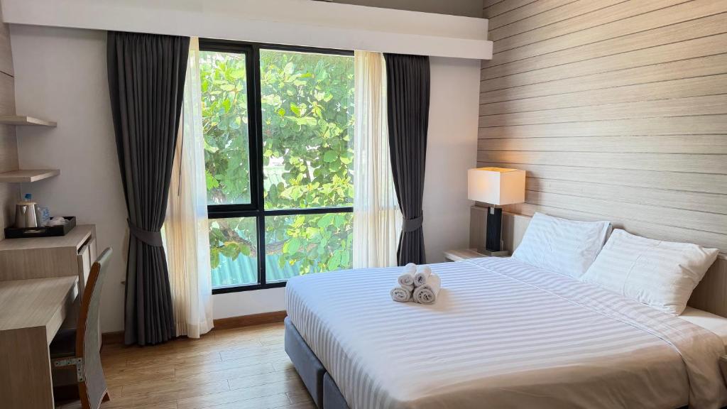 a bedroom with a bed with two stuffed animals on it at Du Talay Hotel Koh Chang in Ko Chang