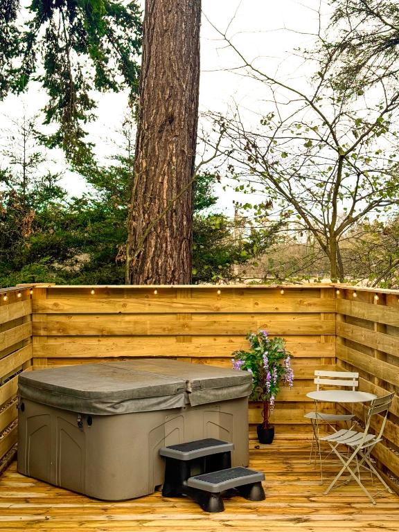 a hot tub on a wooden deck with a tree at Boann 5 - Hot Tub-Hunting Tower Lodges-Luxury-Families-Romantic in Perth