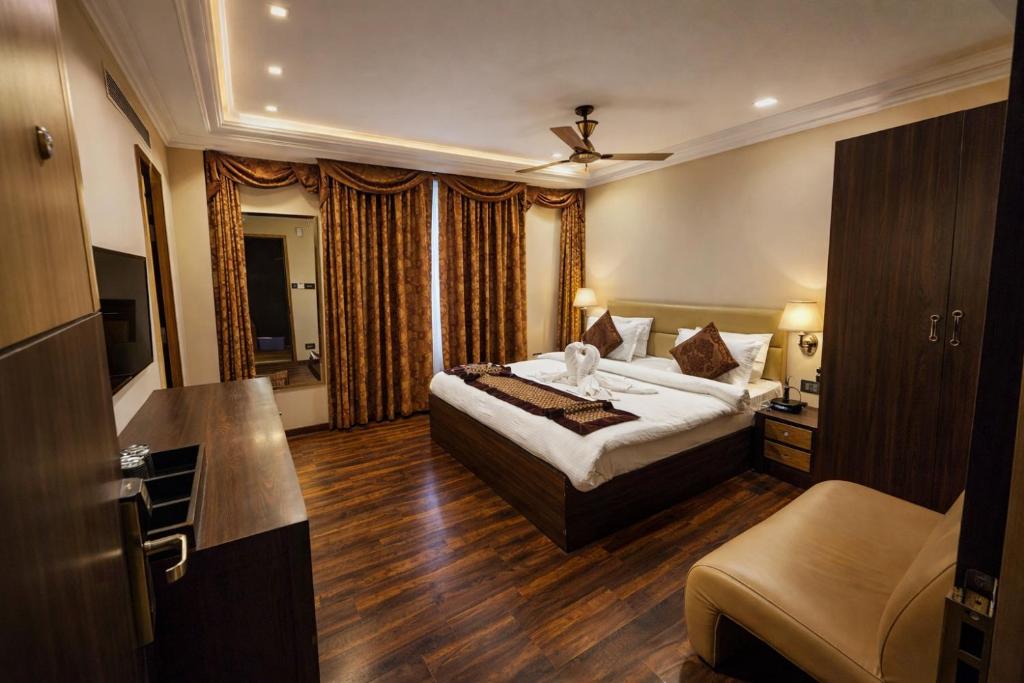 a hotel room with a bed and a bathroom at Arcadian Hotel in Gangtok