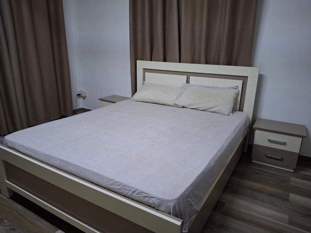 a bedroom with a large bed with a white bedspread at Authentic South in Mahébourg