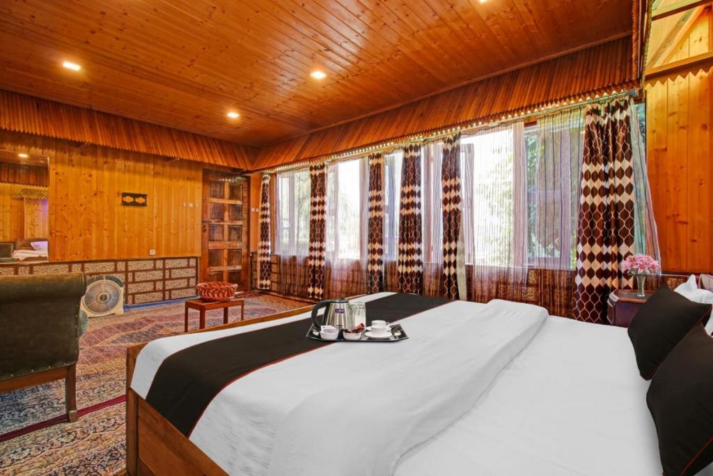 a large bed in a room with wooden walls at Hotel Lake Side in Srinagar