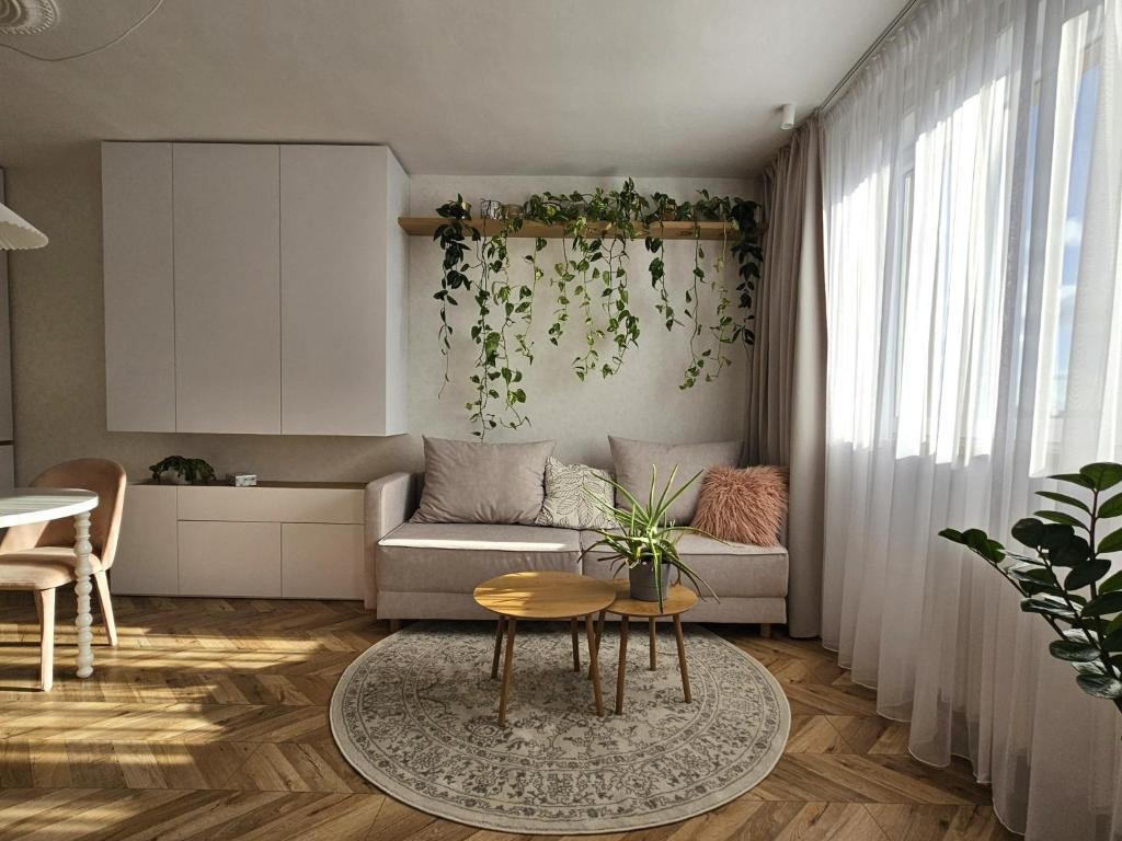 a living room with a couch and a table at LAM Design Greenery AC - Balcony in Bratislava