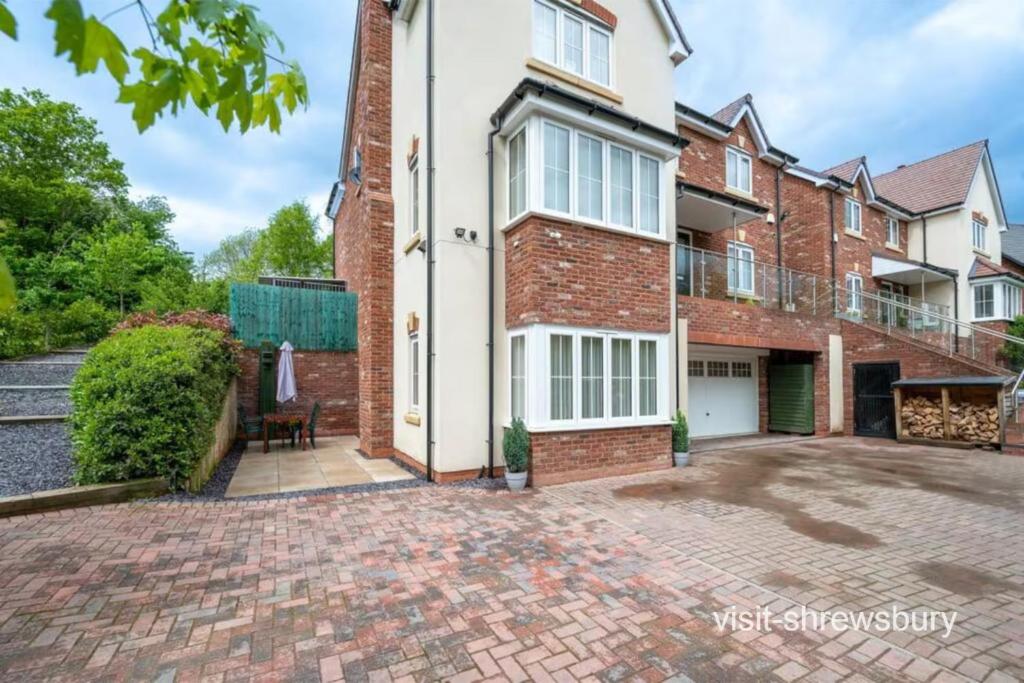 an exterior view of a house with a brick driveway at Personal En-suite in Shrewsbury