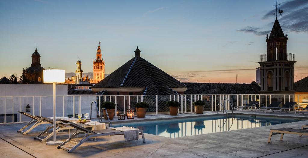 a hotel room with a balcony overlooking the ocean at Hotel Fernando III in Seville