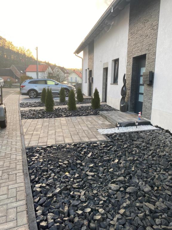 a car parked next to a building with a stone driveway at Spacious home in quiet surroundings in Schwanden