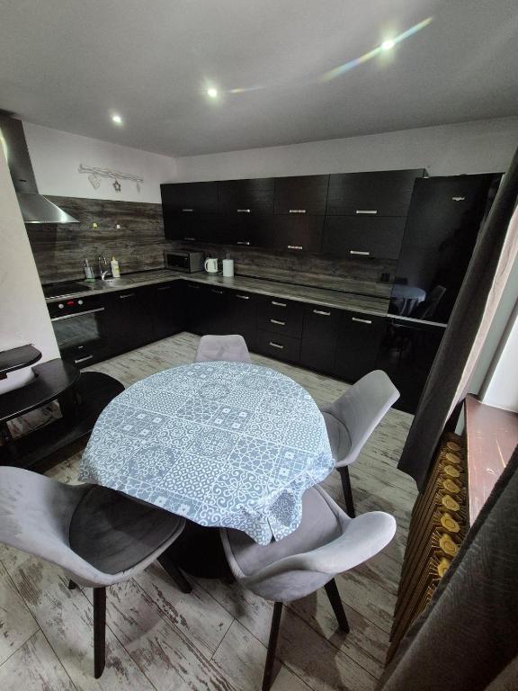 a kitchen with a table and some chairs and a table with an umbrella at Chillout Place in Wieprz