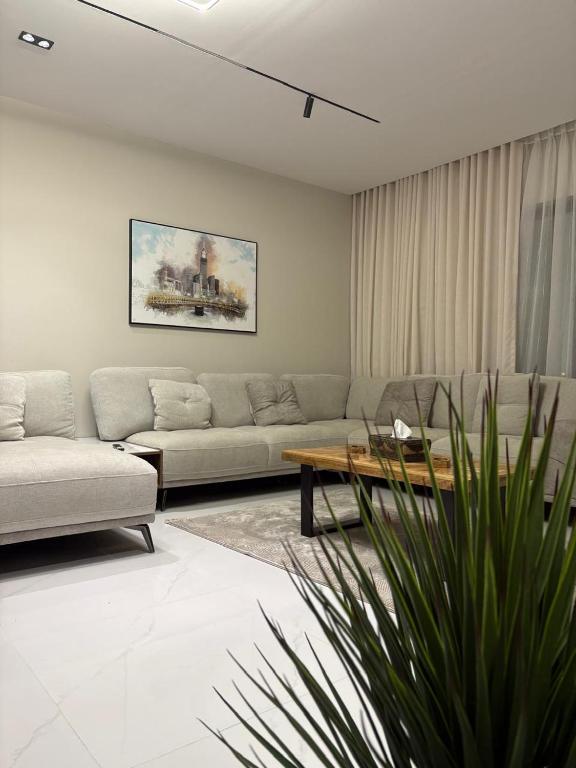 a living room with a couch and a table at شقة قباء in Medina