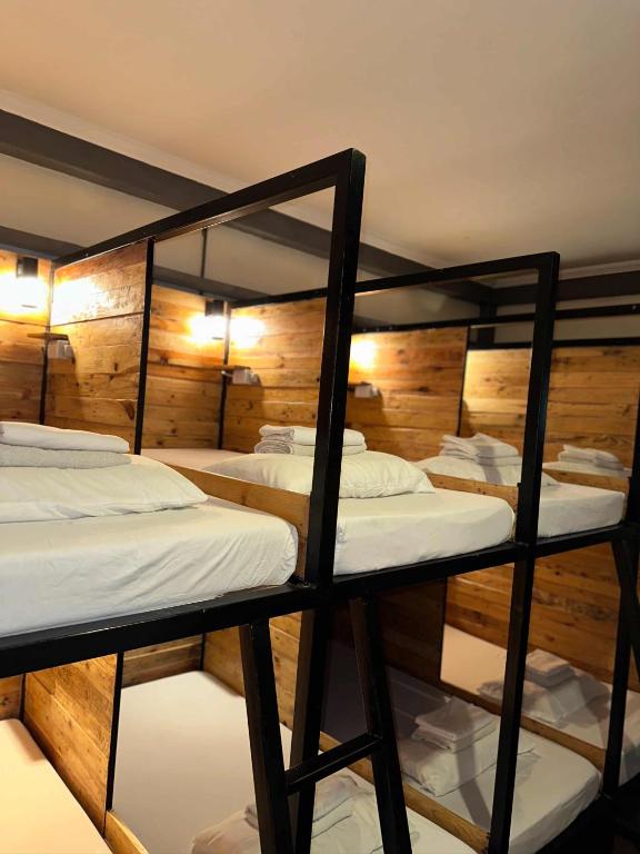 two bunk beds in a room with wooden walls at Yellow Umbrella Hostels in Cebu City