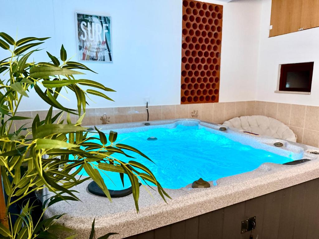 a pool in a room with a plant at Escapada amarela SPA et détente in Mariquiteira