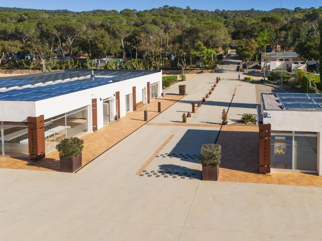 an overhead view of a building with solar panels on the roof at Camping Ridaura in Llagostera