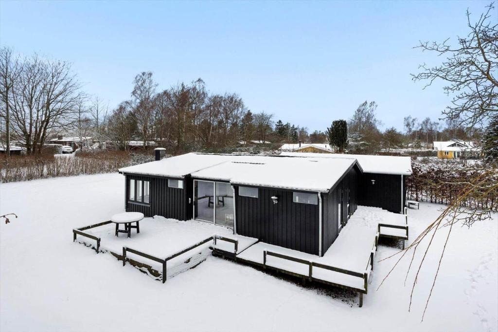 a black building with snow on the ground at LL267-Tranekaer-Bellisvej-2 in Stoense