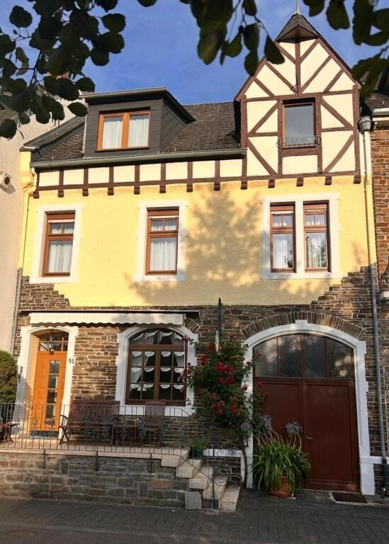 a yellow brick house with a red door at Ferienhaus Knecht in Neef