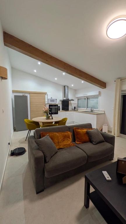a living room with a couch and a table at Chez Lucia petite maison a la campagne pour 4 pers ,parking prive in Istres