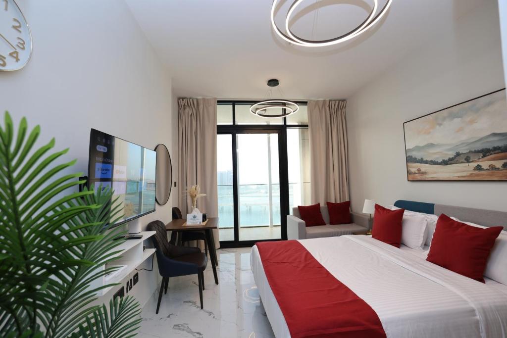a hotel room with a bed and a desk and a room at Modern Waterfront Studio | Steps from Cleveland Clinic in Abu Dhabi