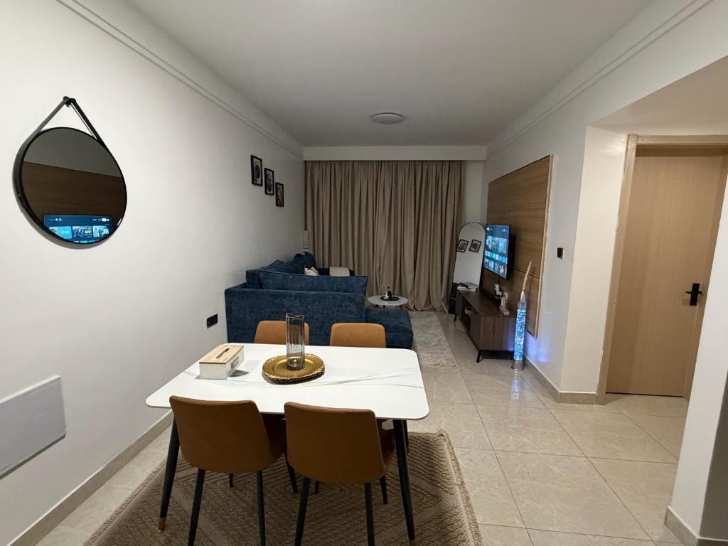 a living room with a white table and chairs at Homiq Stays near UN & Village Market - 1 bedroom in Ruaka