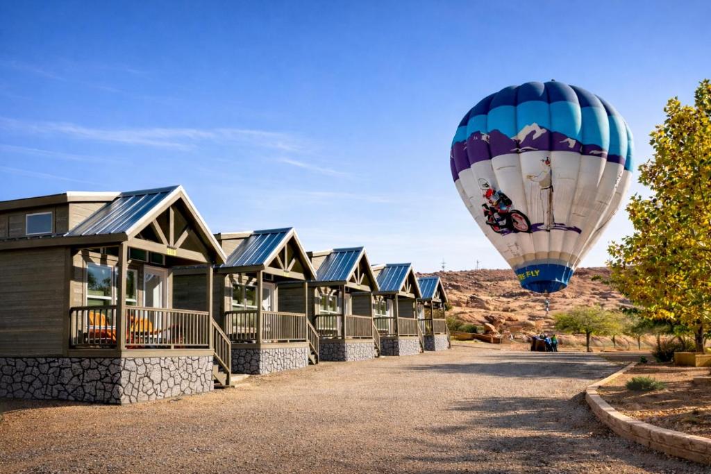 a hot air balloon flying over a row of houses at Page Lake Powell Campground - Tiny Home King Room in Page