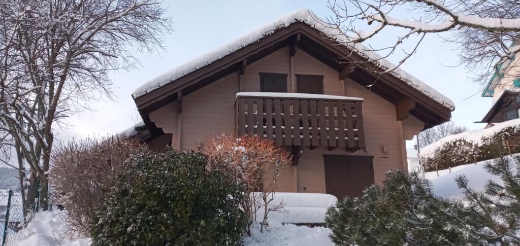 a house with snow on the front of it at Chalet Les Sapins Argentés in Gérardmer