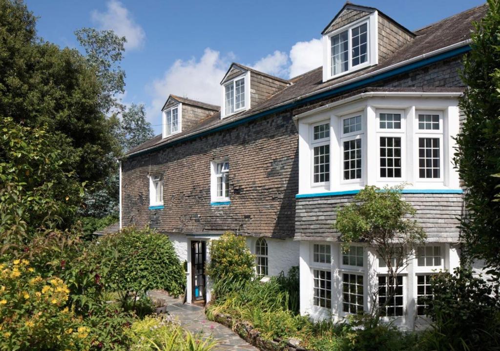 an exterior view of a house with white windows at 1605 by the sea in Falmouth