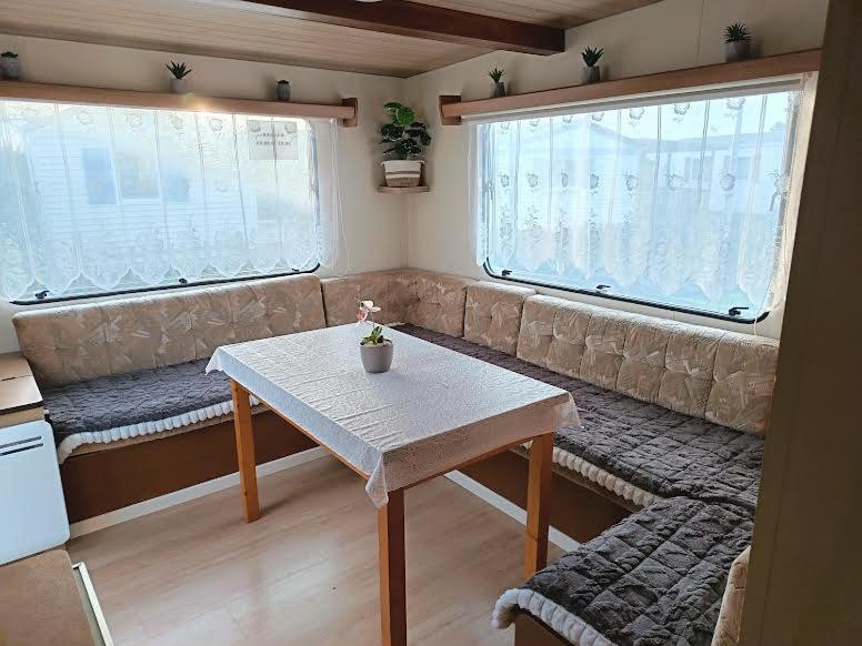 a living room with a couch and a table at Mobil home inter in Berck-sur-Mer