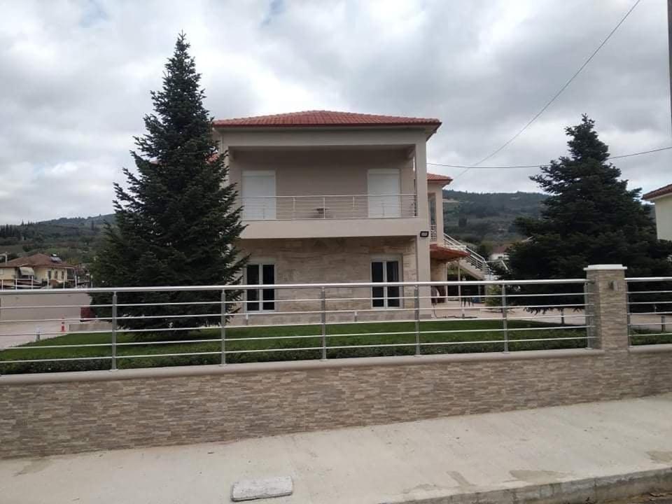 a house with a fence in front of it at Studio Giannis, a breath away from Athens! in Neméa