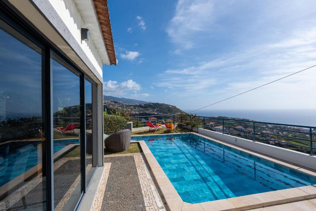 a swimming pool on the roof of a house at Villa Liana by LovelyStay in Ponta do Sol