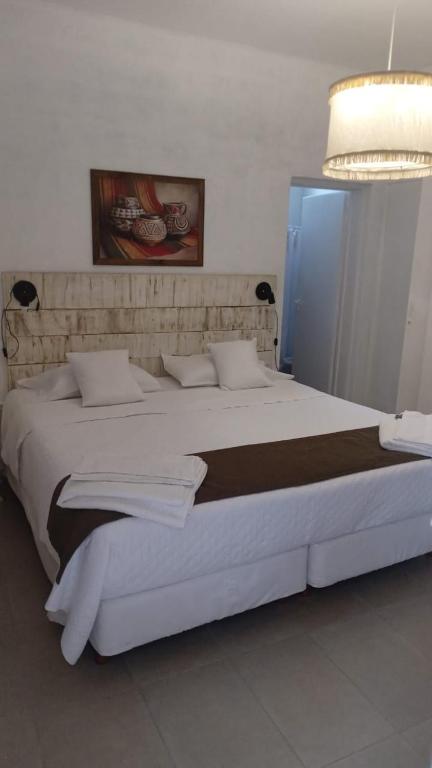 a large white bed in a room with a light at Alojamiento San Nicolas in La Rioja