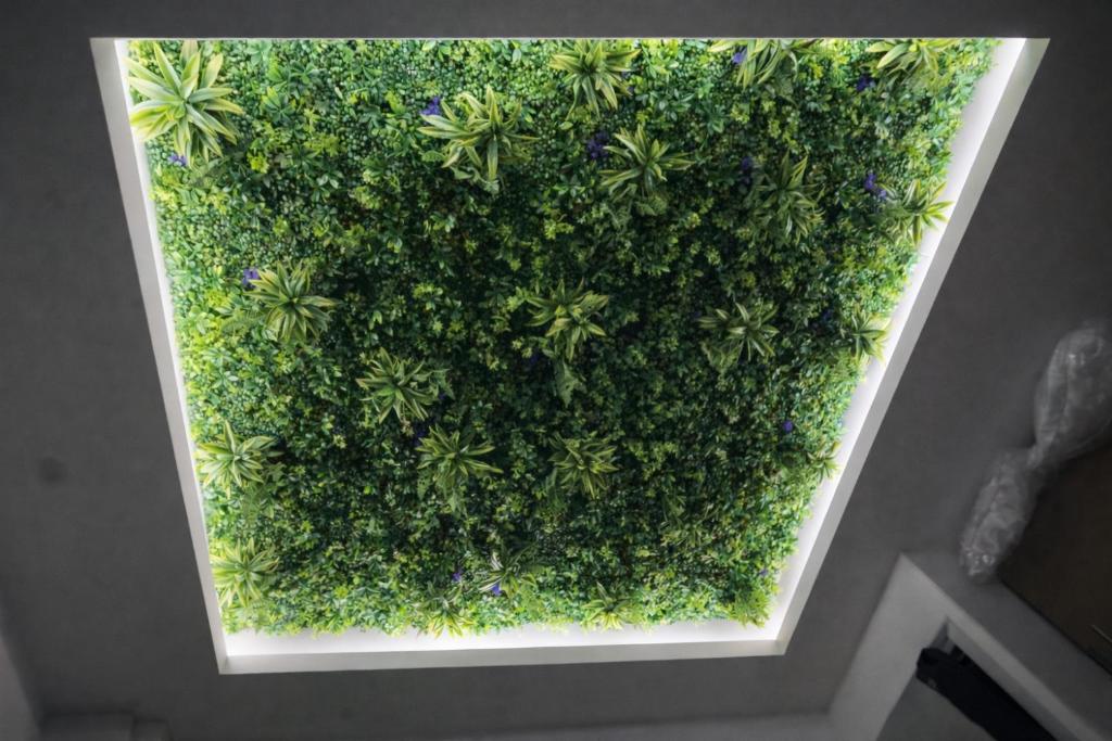 a green wall with plants on it in a room at Appart'Hôtel 23 Le Cocon Creusois Studio in Guéret