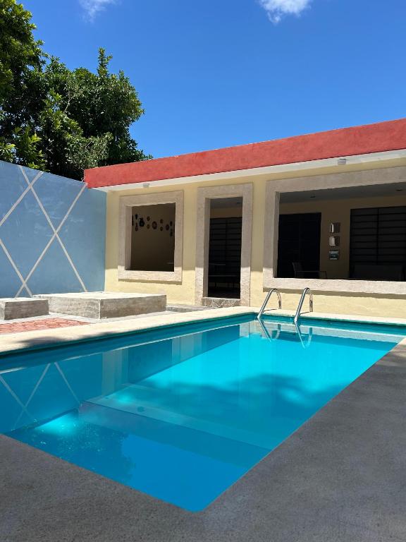 a swimming pool in front of a house at Casa 3 Torres, Calle 76 in Mérida