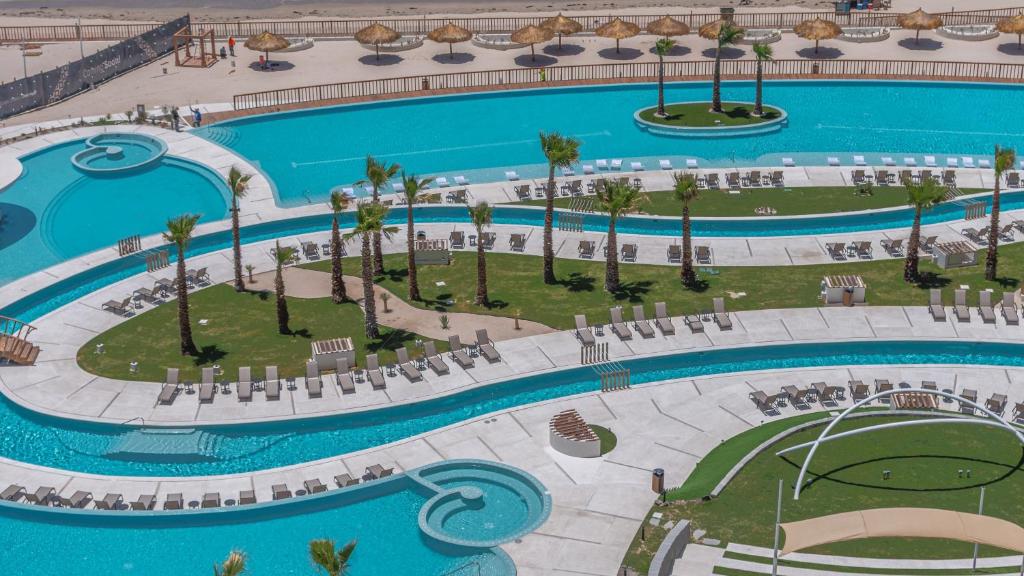 an overhead view of a swimming pool at a resort at Elegant Ocean Getaway Designed for Relaxation and Luxury in Puerto Peñasco