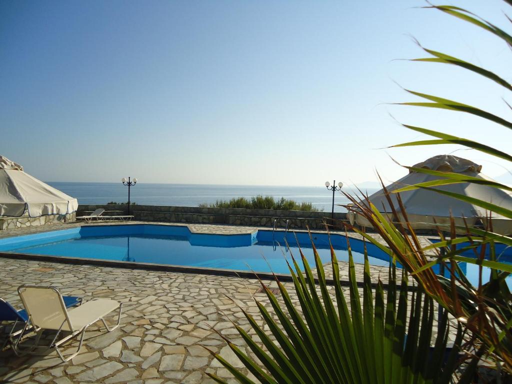 a swimming pool with a view of the ocean at Vangelis Villas in Agios Nikolaos