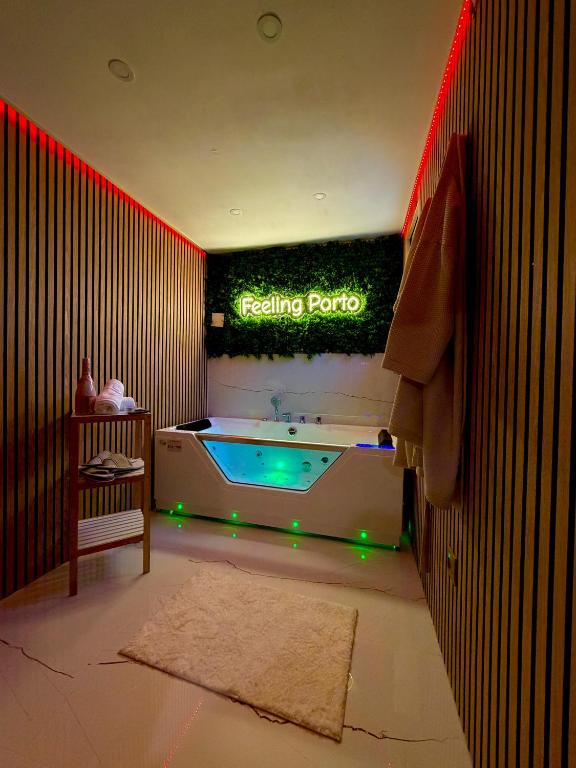 a bathroom with a tub with a sign on the wall at Feeling Porto House in Porto