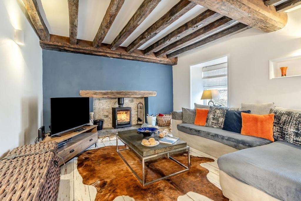a living room with a couch and a fireplace at 3 Bed in Brancaster oc-h27159 in Brancaster