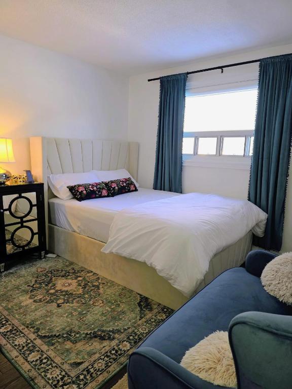 a bedroom with a large bed and a window at Private Bedroom with Ensuite in Toronto