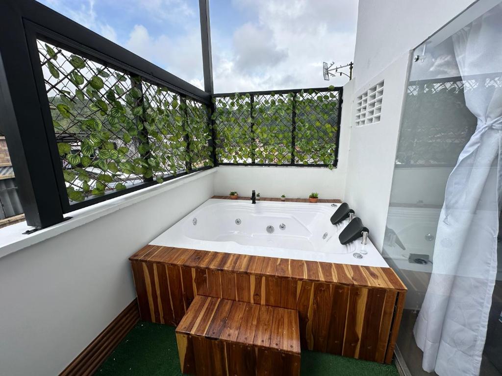 a large bathroom with a tub and a large window at Apartamentos FM 401 in Líbano
