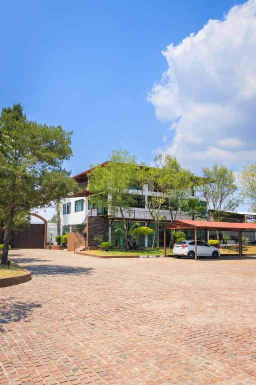 a building with a car parked in front of it at Habitación Privada in Jacuaro