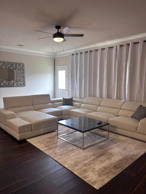 a living room with a couch and a coffee table at 5bd Beautiful Modern home in Spring in Spring
