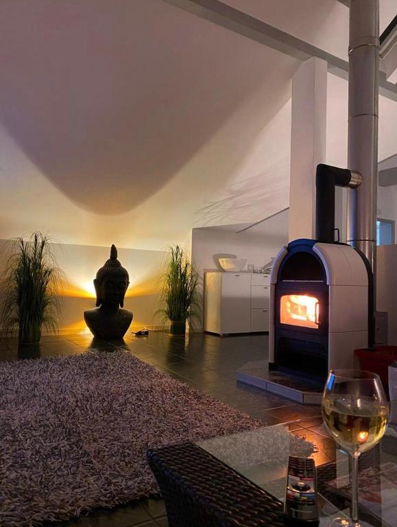 a living room with a fireplace and a wine glass at Viktoria`s Penthouse in Bad Breisig