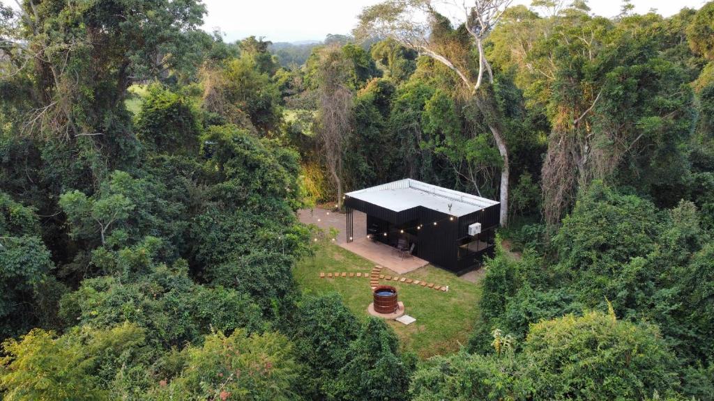 an overhead view of a black house in a forest at RASTRO Cabins in Restinga Sêca
