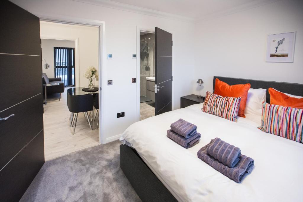 a bedroom with a large bed with two pillows on it at Lewis Living in Isle of Lewis